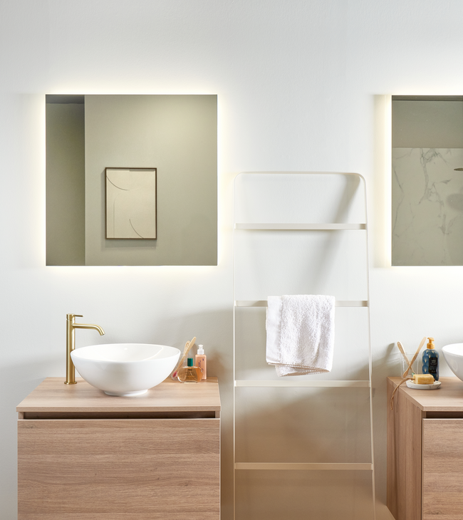 Moderne badkamer met houten meubels en spiegel met indirecte verlichting voor een stijlvolle en warme uitstraling.